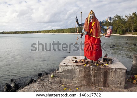 Statue of Kali, Hindu goddess, in outdoor temple on beach of Mont Choisy, Mauritius island