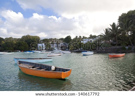 Wooden fishing boats in ocean in harbor on Mauritius