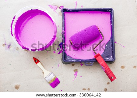 a bucket of paint and a brush roller paint tray