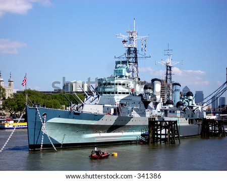 This is a warship in London called the Ark Royal, in the background can be seen the Tower of London.
