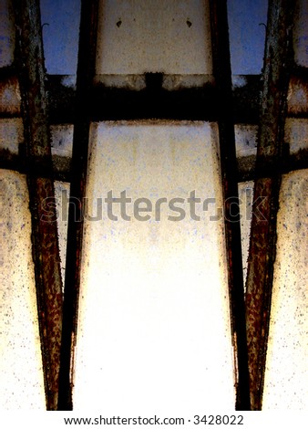 An abstract photographic image created out of some dirty windows with some rusty window frames.