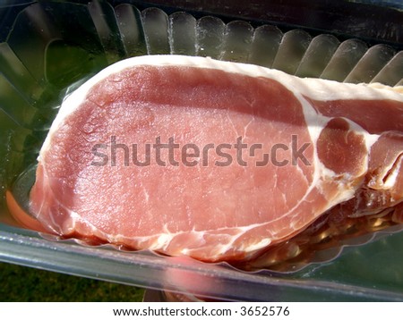 An image of some sliced bacon within its package.