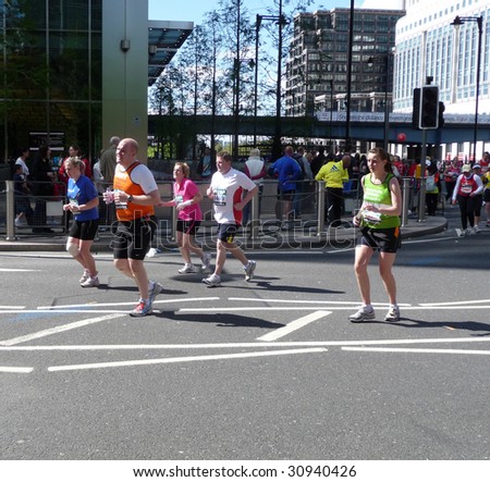 LONDON - APRIL 26 : Runners in action during Flora London Marathon April 26, 2009 in London. Olympic champion Sammy Wanjiru won the 2009 edition.