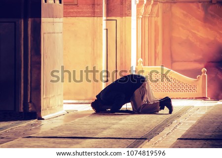 The muslim prayer for god in the mosque. Old iranian Muslim is on his knees praying. Holy month of Ramadan Muslims. Moslem, mohammedan, muslimah. monk, friar, monastic,