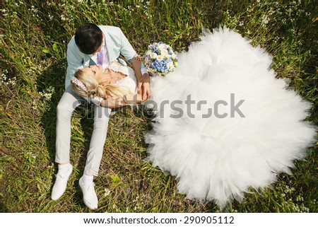Very beautiful bride and groom in a field where many colors and beautiful nature