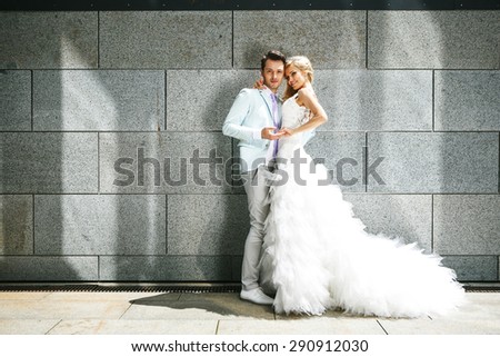 Bride and groom walking around among the houses and buildings