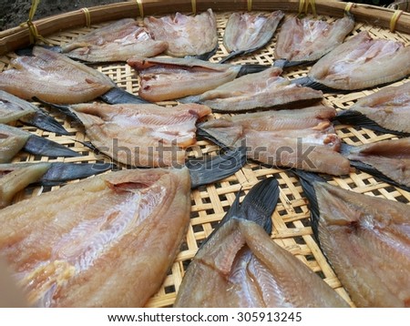 Dry salted fish on bamboo floor