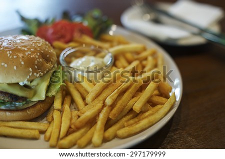 French fries and hamburgers, in a white dish.
