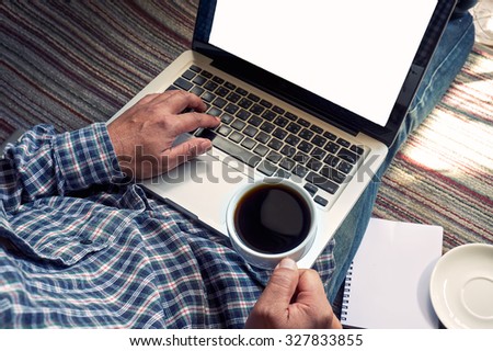 Vintage man laptop and coffee on carpet at office