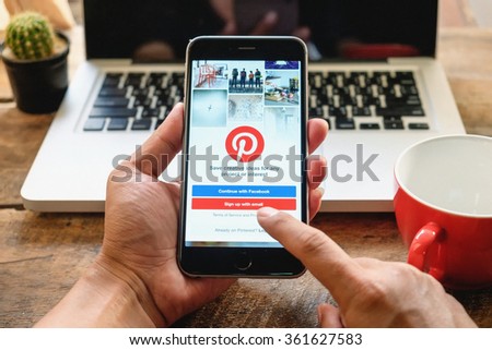 CHIANG MAI,THAILAND - JAN 13,2016 : Man holding a iPhone 6 Plus with social Internet service Pinterest on the screen. iPhone 6 Plus was created and developed by the Apple inc.