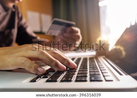 Business man hands using laptop and holding credit card with digital layer effect diagram as Online shopping concept