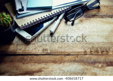 Office workplace with digital smartphone pen notepad and green plant. Creative studio concept