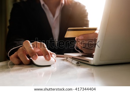 Man hands using laptop and holding credit card with social media as Online shopping concept in morning light