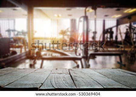 fitness gym and wooden table space in morning light