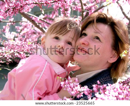 mother and daughter in the middle of blossomed trees