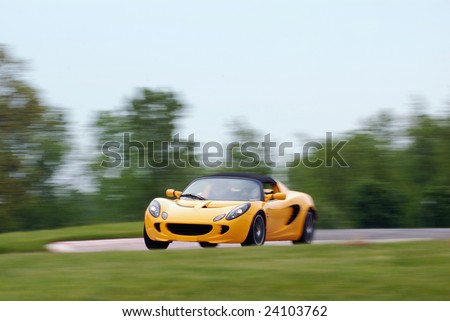 Yellow sports car racing at a open track day