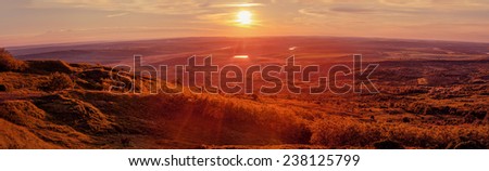 Beautiful landscape panorama with fields and setting sun, meadows, lake and horse grazing. Moldova, Bahmut. In the red light of the sun\'s rays.