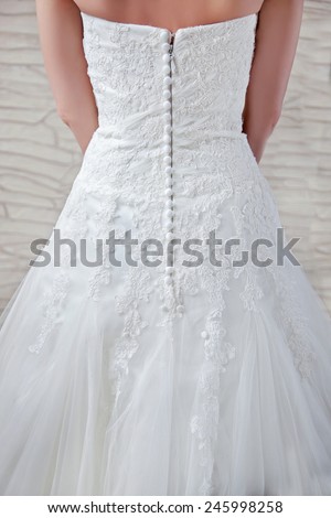 View of the back, beautiful openwork patterns, lace - decorated top dresses, waist, long zip with buttons.