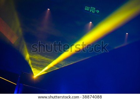 ray of laser yellow light in ultraviolet at disco club