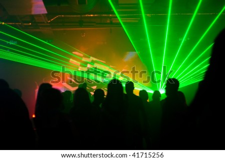 dancing people at the nightclub in ultraviolet light