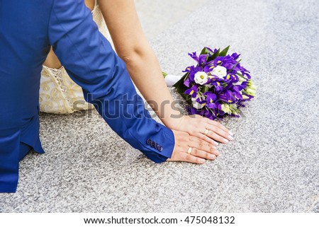Beauty bride and handsome groom are wearing rings each other. Wedding couple on the marriage ceremony. Bride and groom's hands with wedding rings, Hands with wedding rings and fower bouquet