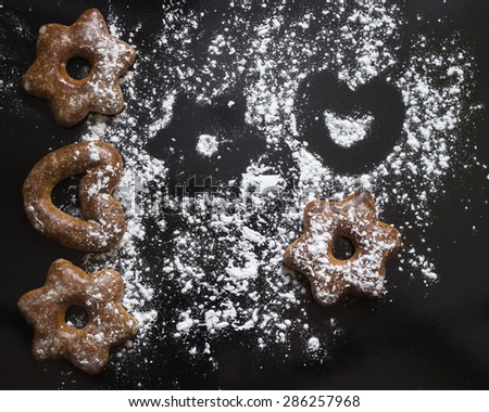 Bavarian cookies iced with sugar powder on the black background