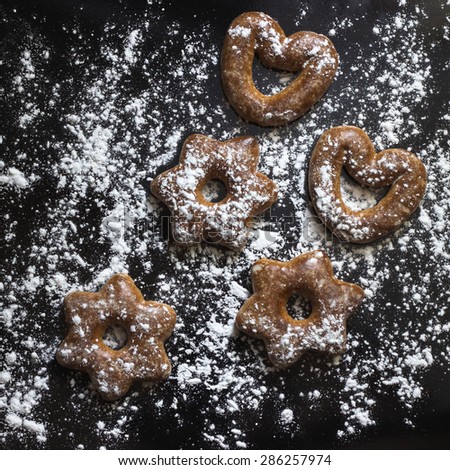 Bavarian cookies iced with sugar powder on the black background