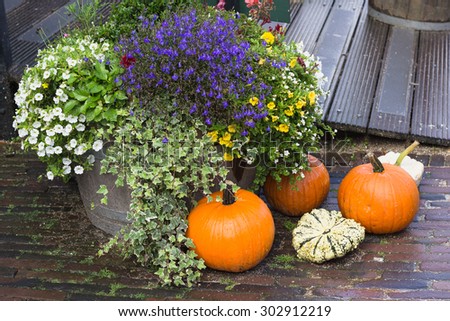 Fall decoration for the yard with pumpkins and flowers