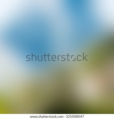 blurry natural and blue sky background. Horizontal composition defocused image space for text. Blue gray green and yellow colors.