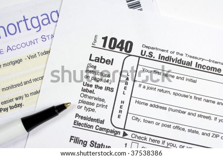 Ball point pen and US IRS 1040 form and mortgage statement