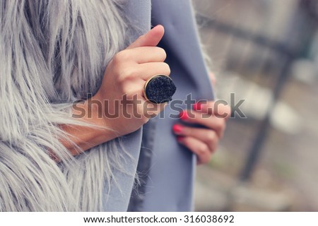 fashion and style girl holding her coat/manicured nails