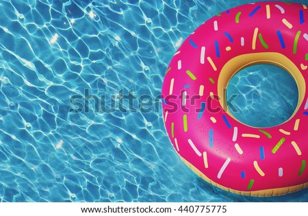 Hipster sprinkled donut float in sunny pool background straight down on bright clear pool water, vivid filter