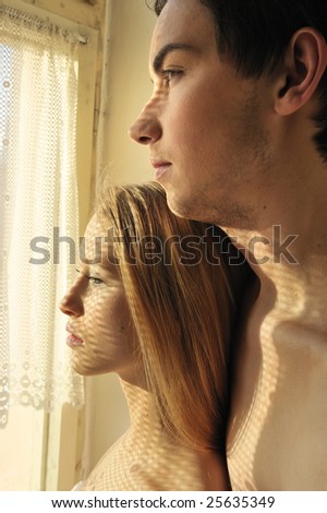 young couple in love looking out of the window