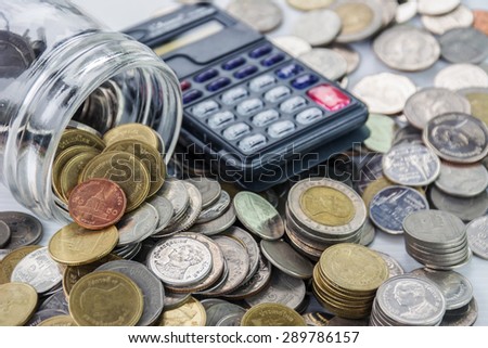 coins and calculator for growing business - Saving money