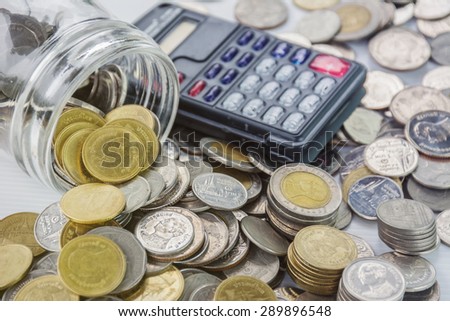 coins and calculator for growing business - Saving money