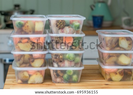 Meal prep. Stack of home cooked roast chicken dinners in containers ready to be frozen for later use as quick and easy ready meals.