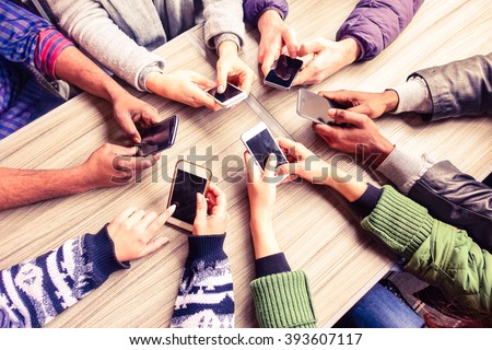 Top view hands circle using phone in cafe - Multiracial friends mobile addicted interior scene from above - Wifi connected people in bar table meeting - Concept of teamwork main focus on left phones