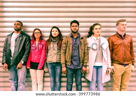 Multiracial serious people lineup as mugshot is standing next to metal rolling shutter - Unemployed multi ethnic friends line up outdoor - Concept of discrimination and youth concern for the future