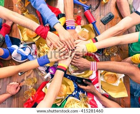 Hands on top each other sport fans party view from above at cafe bar restaurant -   Multiracial group of soccer supporter peace deal meeting - International team work and fun together in joyful moment
