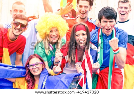 Mixed football fans cheering together - Multiracial soccer supporters singing and screaming at stadium - Concept of brotherhood and friendship in sports and life - Main focus on right woman