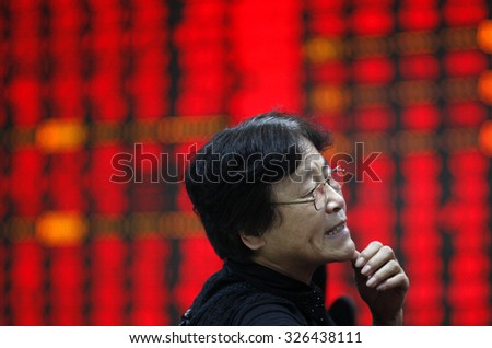 An investor watchs electric board in a stock market in Huaibei, Anhui province, east China on 8th August  2015.
