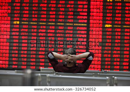 An investor watchs electric board in a stock market in Huaibei, Anhui province, east China on 12th October 2015.