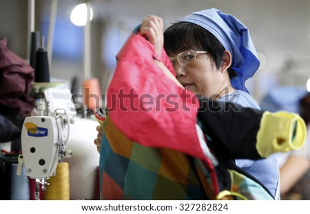 A female labour works in a textile clothes factory in Huaibei, Anhui province, east China on 1th September  2015.