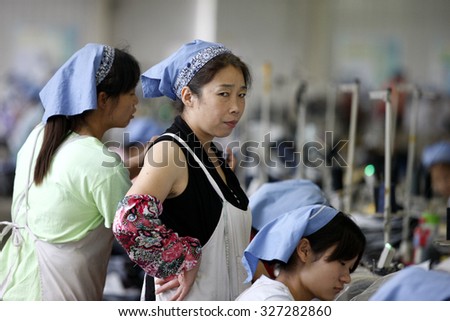A female labour works in a textile clothes factory in Huaibei, Anhui province, east China on 1th September  2015.