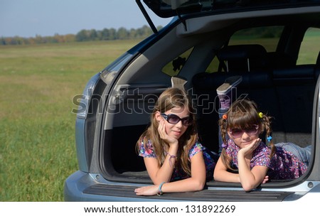 Family car trip on summer vacation, happy smiling kids travel, children having fun. Car insurance concept