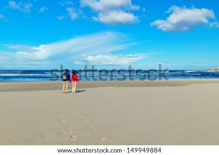 Happy couple on beautiful ocean beach, romantic vacation in South Africa