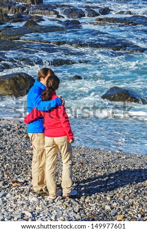 Happy couple on beautiful ocean beach, romantic vacation in South Africa, vertical image