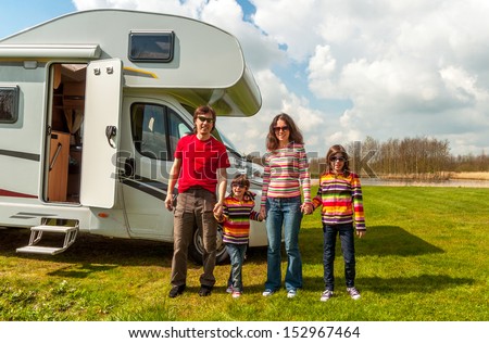 Family vacation in camping, holiday trip in camper. Happy active parents with kids travel on RV. Family having fun near their motorhome. Spring vacation trip with children.