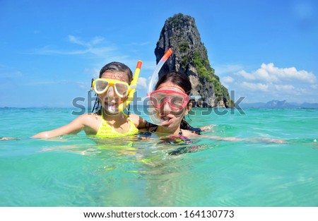 Happy mother and kid snorkeling in tropical sea, family beach vacation