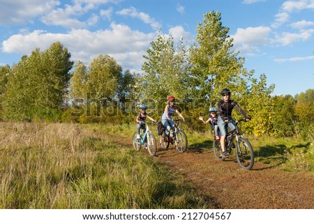 Happy family on bikes, cycling with kids